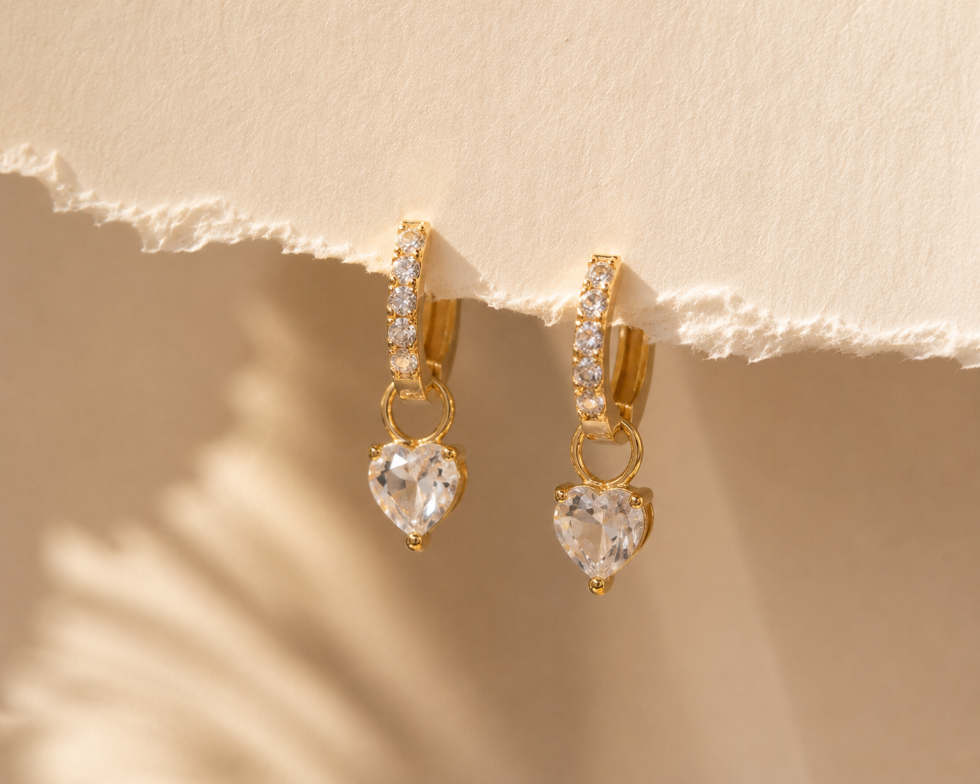Minimal gold heart huggie earrings for daily wear